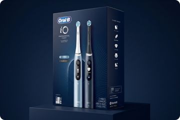 Oral-B iO electric toothbrush packaging on a dark blue background