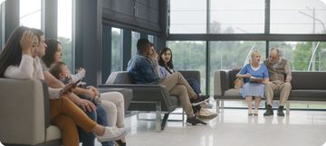 People of different ages waiting in a bright clinic lobby