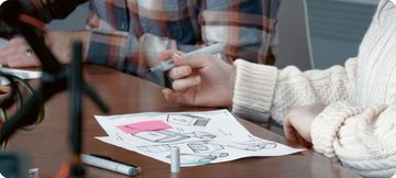Designers sketching product concepts at a table