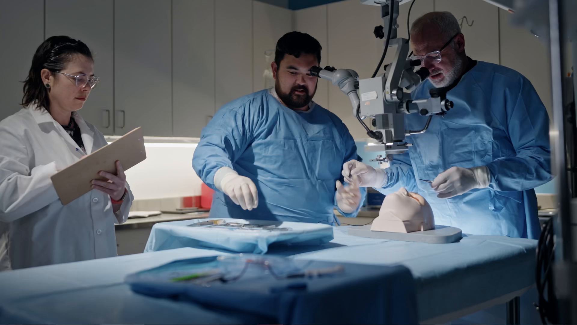 Kaleidoscope clinical and engineering team at a surgical microscope with a training manikin