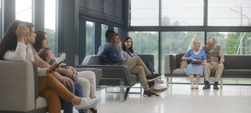 People of different ages waiting in a bright clinic lobby
